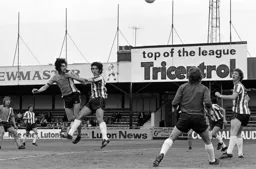 Barry Butlin gets his header away