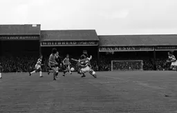Peter Anderson about to be tackled by David Webb