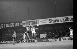 Barry Butlin gets his head to the ball first
