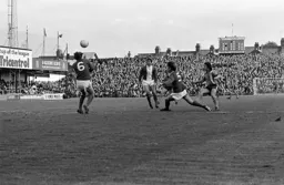 Jimmy Husband shoots for goal watched on by Howard Kendall