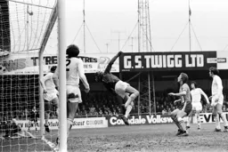 Steve Litt watches Pat Jennings tip over