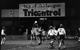 Burnley keeper challenged by several Luton players