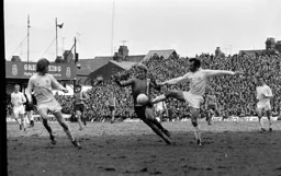 Ron Futcher gets the attention of Reaney and McQueen