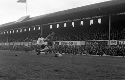 John Aston beats the defender