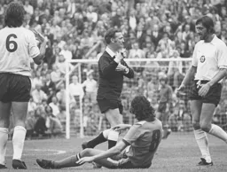 Jones is booked for his foul on Adrian Alston