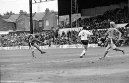 Steve Buckley drives in a shot watched by Ron Futcher