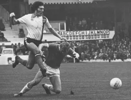 Adrian Alston hurdles Blackpool's Peter Suddaby