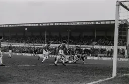 John Aston watches a goalmouth scramble