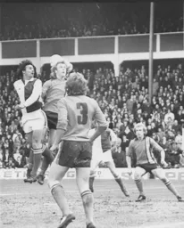 Paul Futcher backheads the ball clear