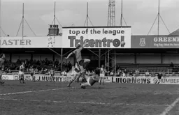 Ron Futcher clatters into the goalkeeper