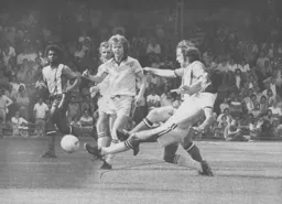 Dixie Deans manages to move the ball on watched by Ricky Hill