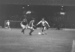 Steve Buckley takes on two defenders