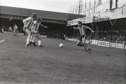 John Aston face by two defenders