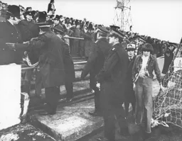 A tearful fan is helped away