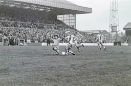 Ron Futcher about to feel the force of future Hatter Mick Saxby