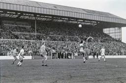 Brian Stein watches on as Ricky Hill tries to get his head to the ball