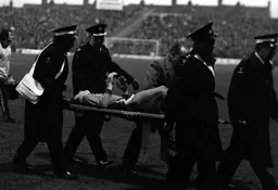 Alan West being stretchered off