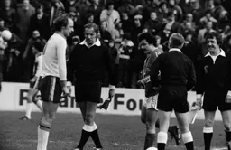 John Faulkner looks cold waiting for the toss