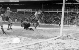 Rover’s defender cannot stop on the ice and has to leap over the keeper