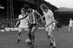 Brian Stein holds off two defenders