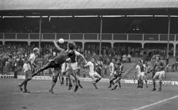 Ricky Hill tries to get his head to the ball in a crowded box