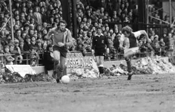 Chris Turner runs past the defender and piles of snow