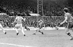 Alan West strikes for goal and the ball is deflected into the Brighton net