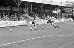 Steve Taylor makes a concerted effort to get to the ball first