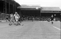 Kirk Stephens hurdles an Orient defender