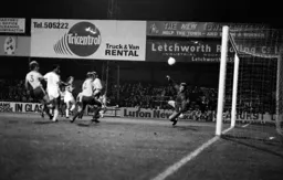 Bob Hatton looks back as his header enters the net