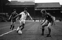 David Moss takes on defender in the box