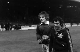 Jake Findlay leaving the pitch with Manager David Pleat