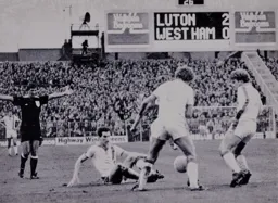Luton players protect the ball