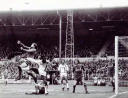 The Latics goalkeeper clears