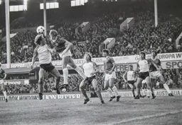 David Geddis watches on as Paul Walsh rises to head the ball