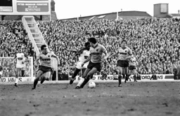 Ricky Hill takes on three defenders