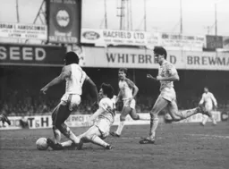 Spurs skipper Steve Perryman puts in a sliding tackle to dispossess Ricky Hill