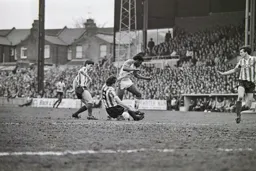 Ricky Hill tackled in midfield