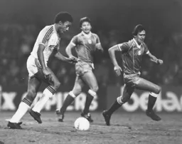 Paul Elliott looks to clear the ball