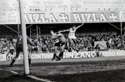 Paul Elliott first to the ball