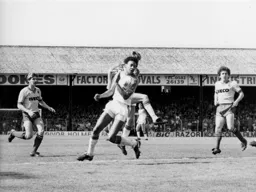 Paul Elliott watches as a shot by Garry Parker heads towards the goal