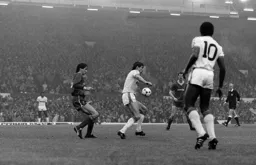 Mick Harford controls the ball in front of Alan Hansen