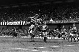 Mick Harford first to the ball