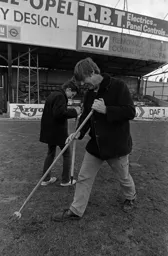 Dick Wassell tries to repair the pitch