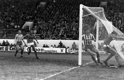 Mick Hartford ends up in the net with the ball for the equaliser
