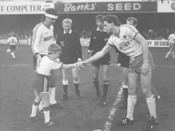 Norwich captain Dave Watson shakes the wrong hand, fooled by the headband, as Town fight back in the relegation battle