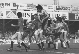 Mick Harford powers above a a pack of players to force the ball home after Foster's free kick rebounds off the bar