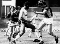 Emeka Nwajiobi beats the posse of Villa players to the admiration of Peter Nicholas in the background