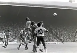 Bruce Grobbelaar punches the ball off the head of Mal Donaghy
