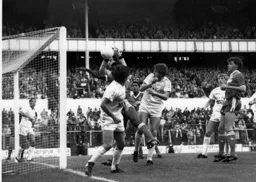 Spurs keeper Ray Clemence catches the ball with Mal Donaghy in close attendance